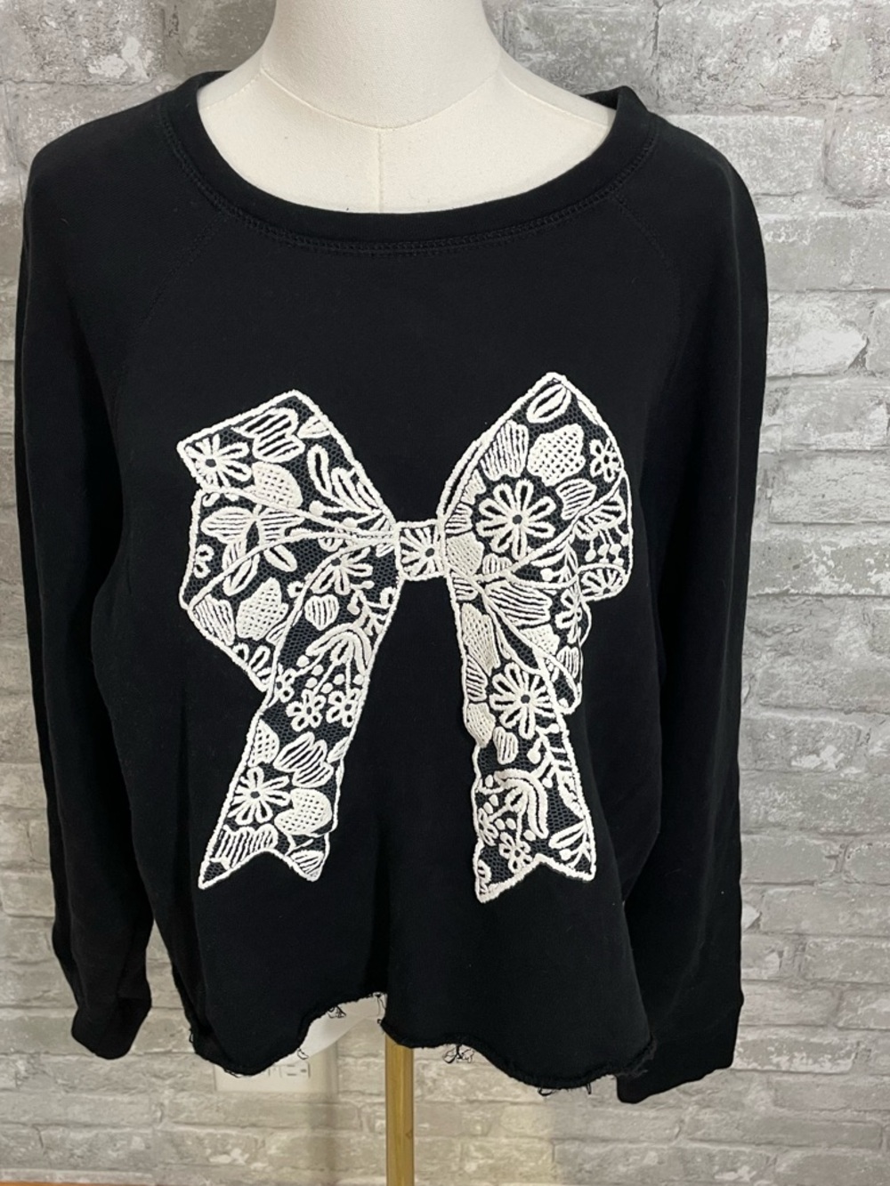 Zutter Black Fleece Sweatshirt with White Lace Bow Applique